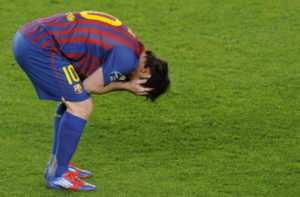 Barcelona's Argentinian forward Lionel Messi holds his head in his hands after losing to Chelsea after the UEFA Champions League second leg semi-final football match Barcelona against Chelsea at the Cam Nou stadium in Barcelona on April 24, 2012. AFP PHOTO / PIERRE-PHILIPPE MARCOU (Photo credit should read PIERRE-PHILIPPE MARCOU/AFP/Getty Images)